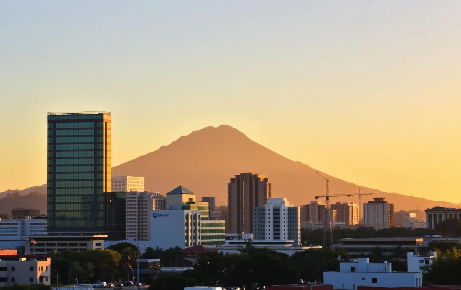 Modern San Salvador skyline at golden hour with volcano in the background